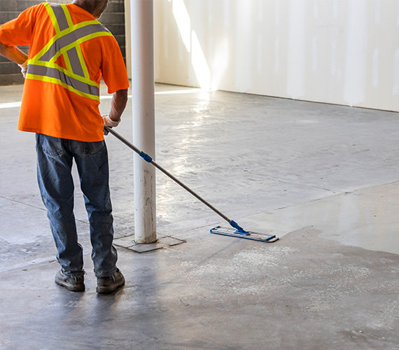 BNE professional concrete installers preparing a concrete floor for finishing